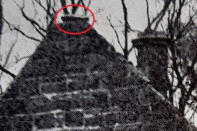 Top of chimney circled in red at peak of roof
